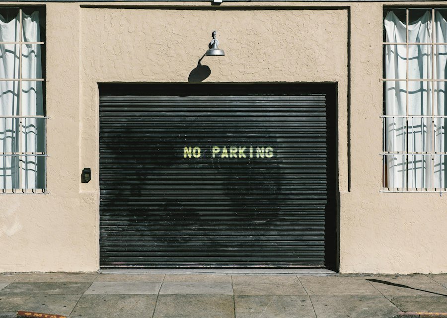 Black metal roll-up door with no parking print