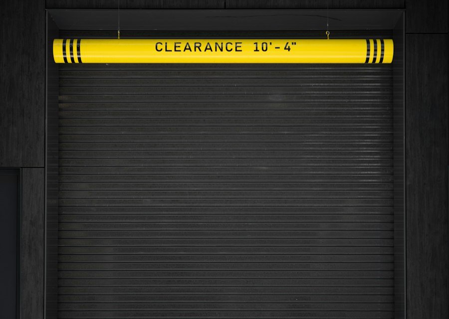 A closed garage door with a yellow sign on it